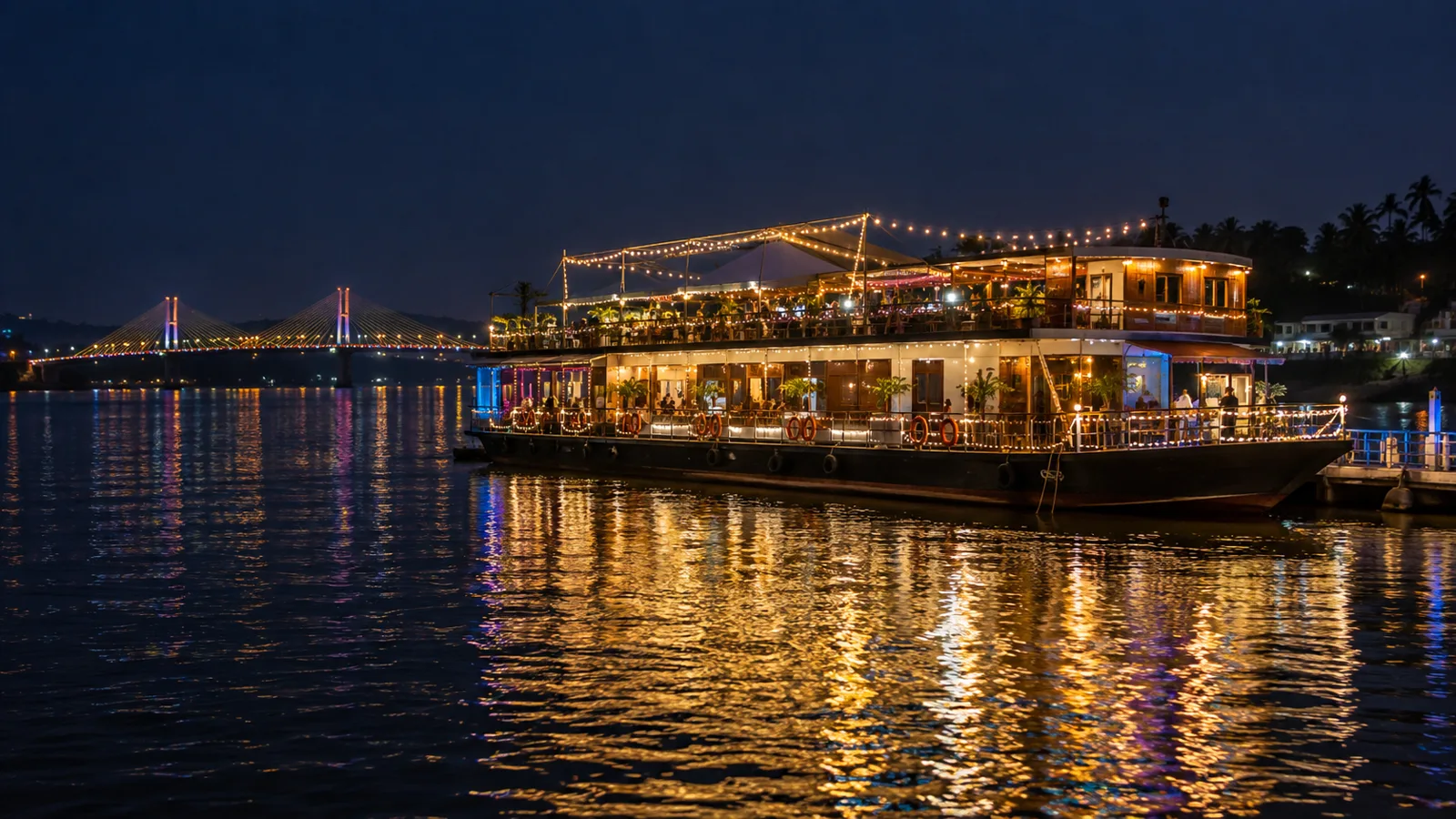 Riverside entertainment vessel lit at night on the Mandovi